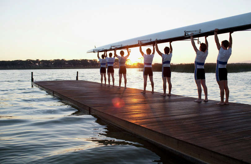 A team holding a rowing boat.
