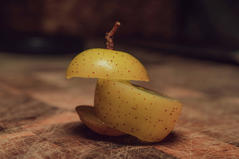 A sliced apple on a cutting board.