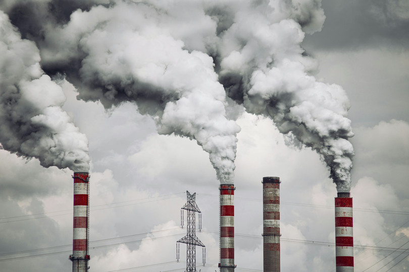 Smoke billowing from smoke stacks.